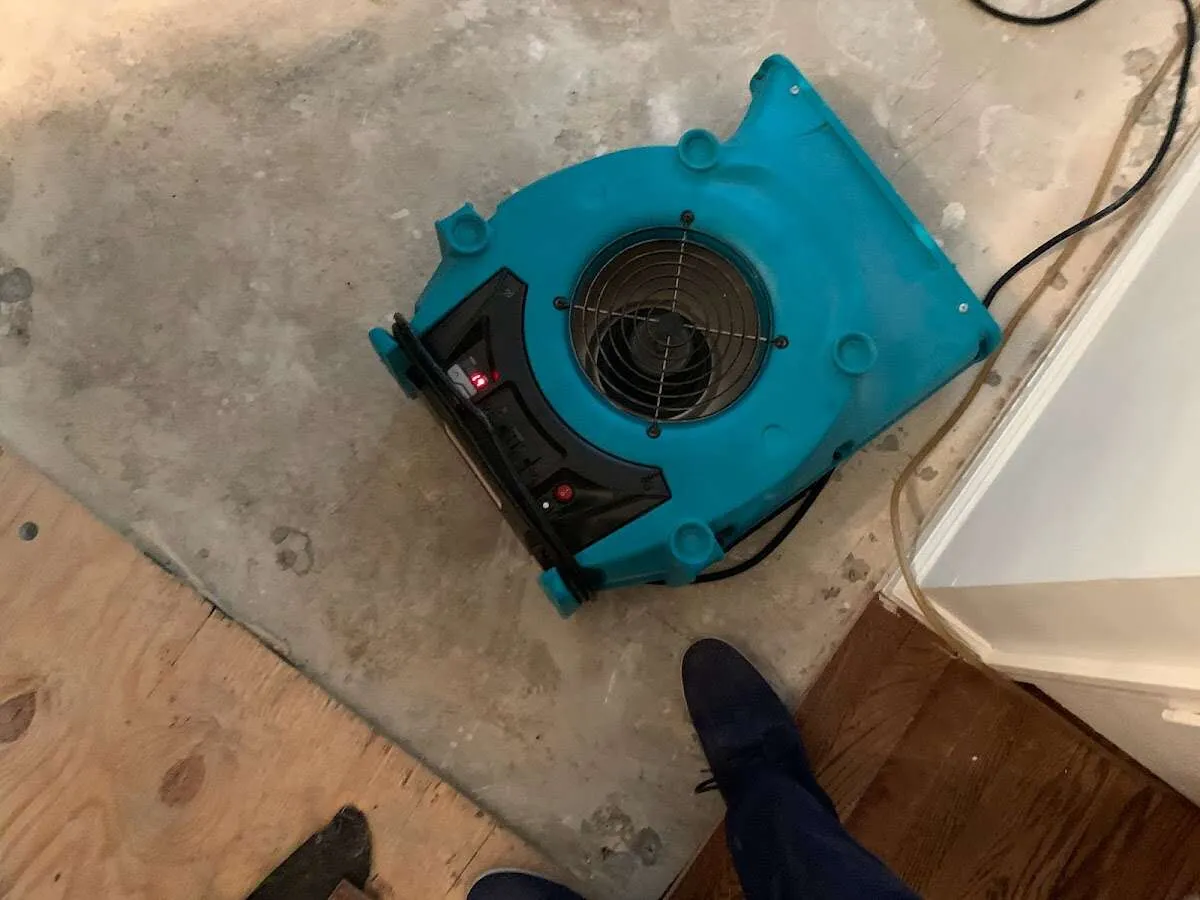 Air mover drying subfloor during Commercial Water Damage Restoration in Waycross